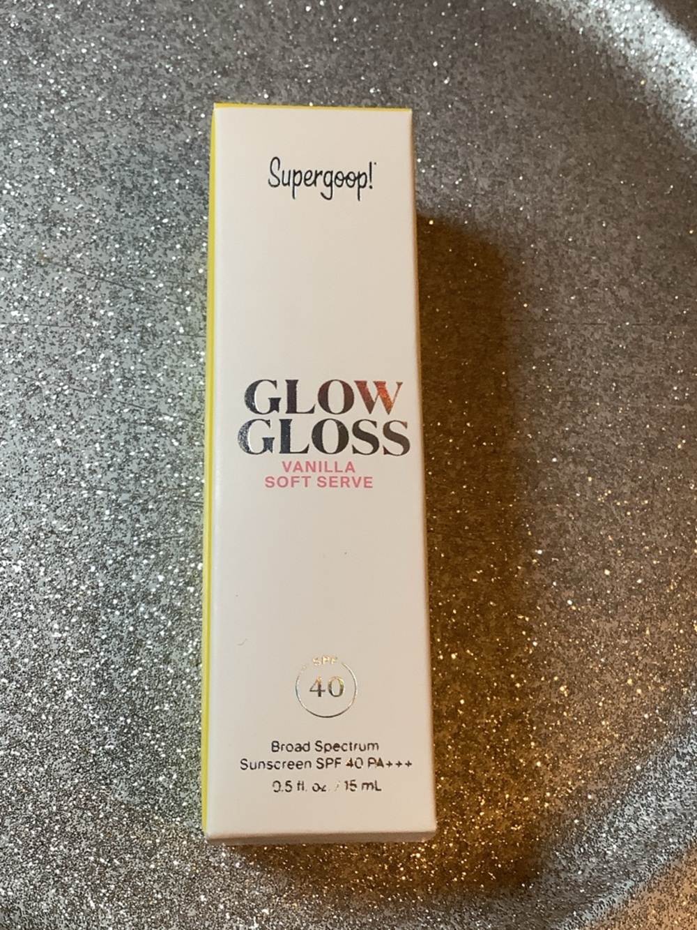 Supergoop! Glow Gloss SPF 40 – Vanilla Soft Serve (White & Yellow Accents)